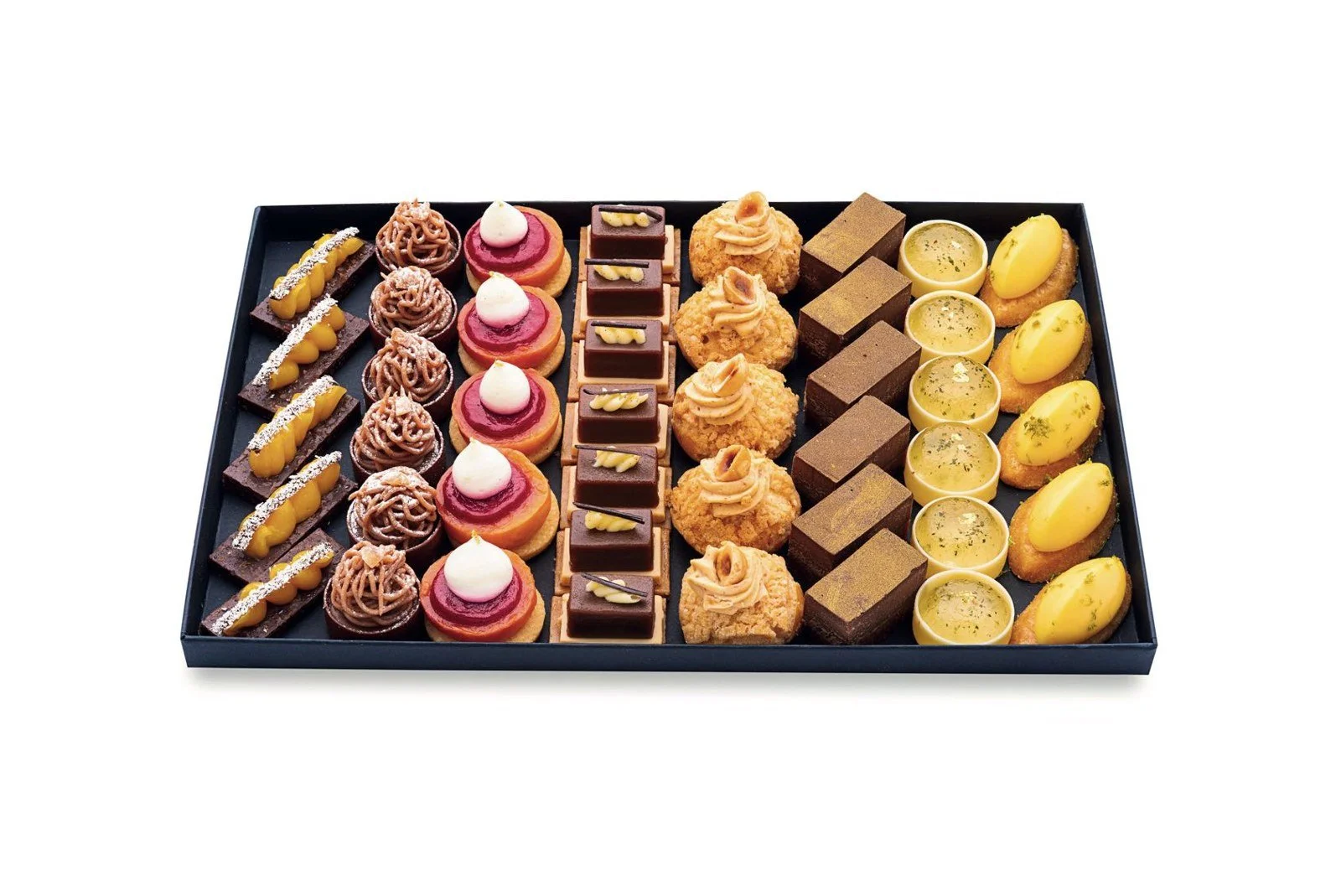 Black tray of French petits fours arranged in neat rows, with chocolate topped and fruit topped mini pastries, ready to serve