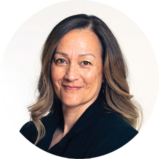 A professional woman with shoulder-length brown hair and a subtle smile, wearing a black top, against a white background with a curved black design.