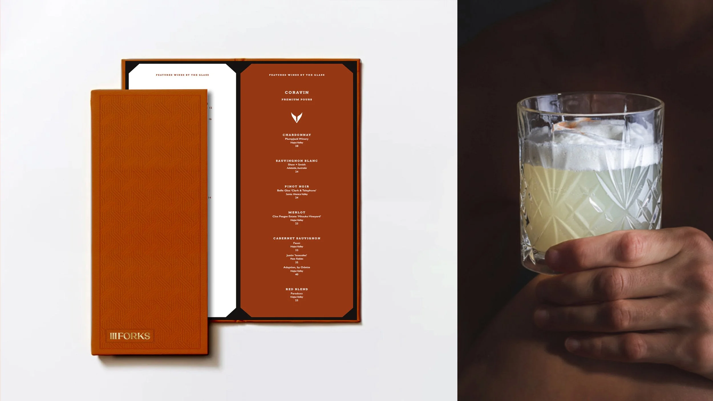 A whiskey glass with a crisscross pattern holding a pale yellow cocktail with ice, held by a person's hand against a dark background.