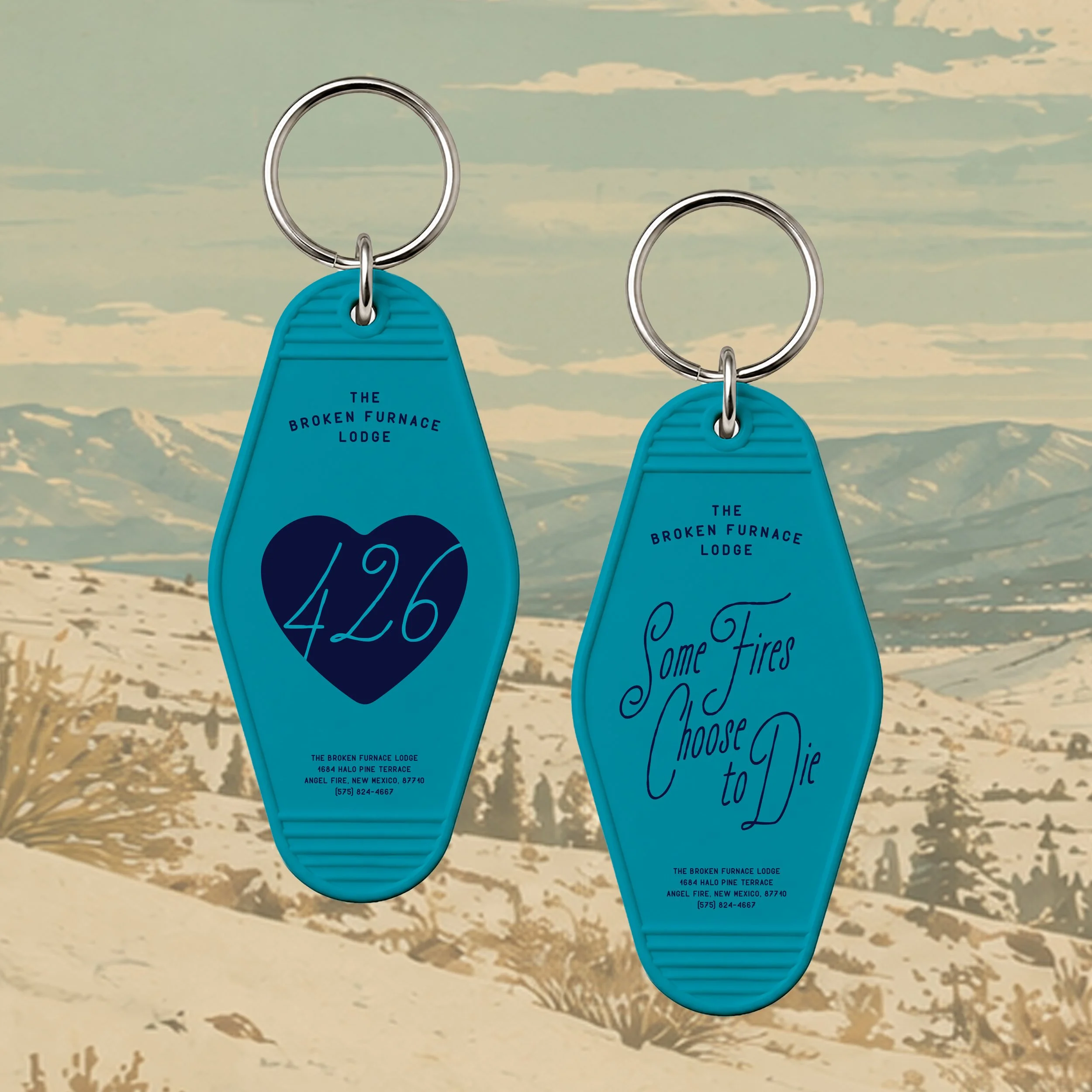 Two blue key tags with black text and a black logo hanging on a metallic hooks against a pastel-colored background with a nature scene.