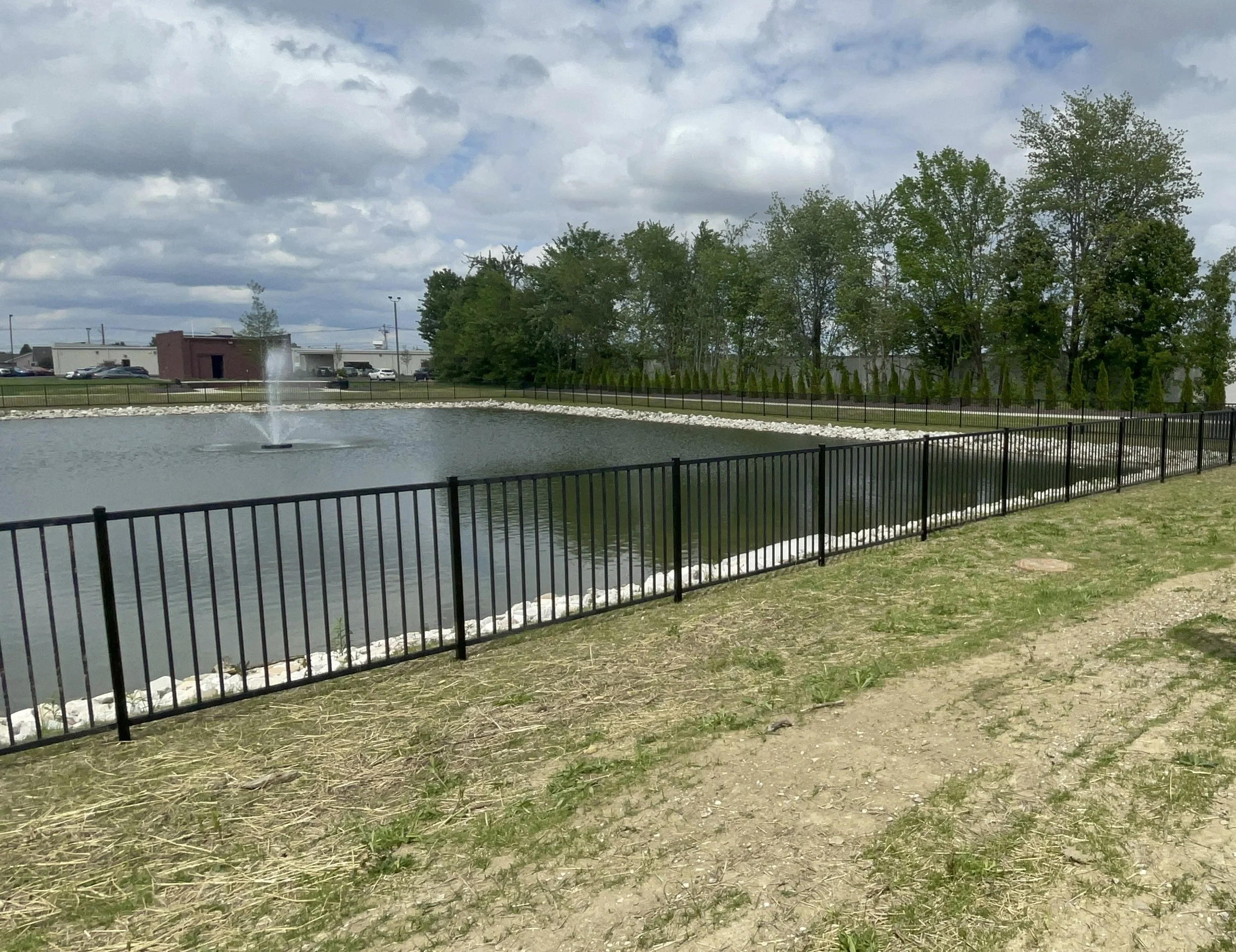 decorative aluminum fence install around a pond.jpg