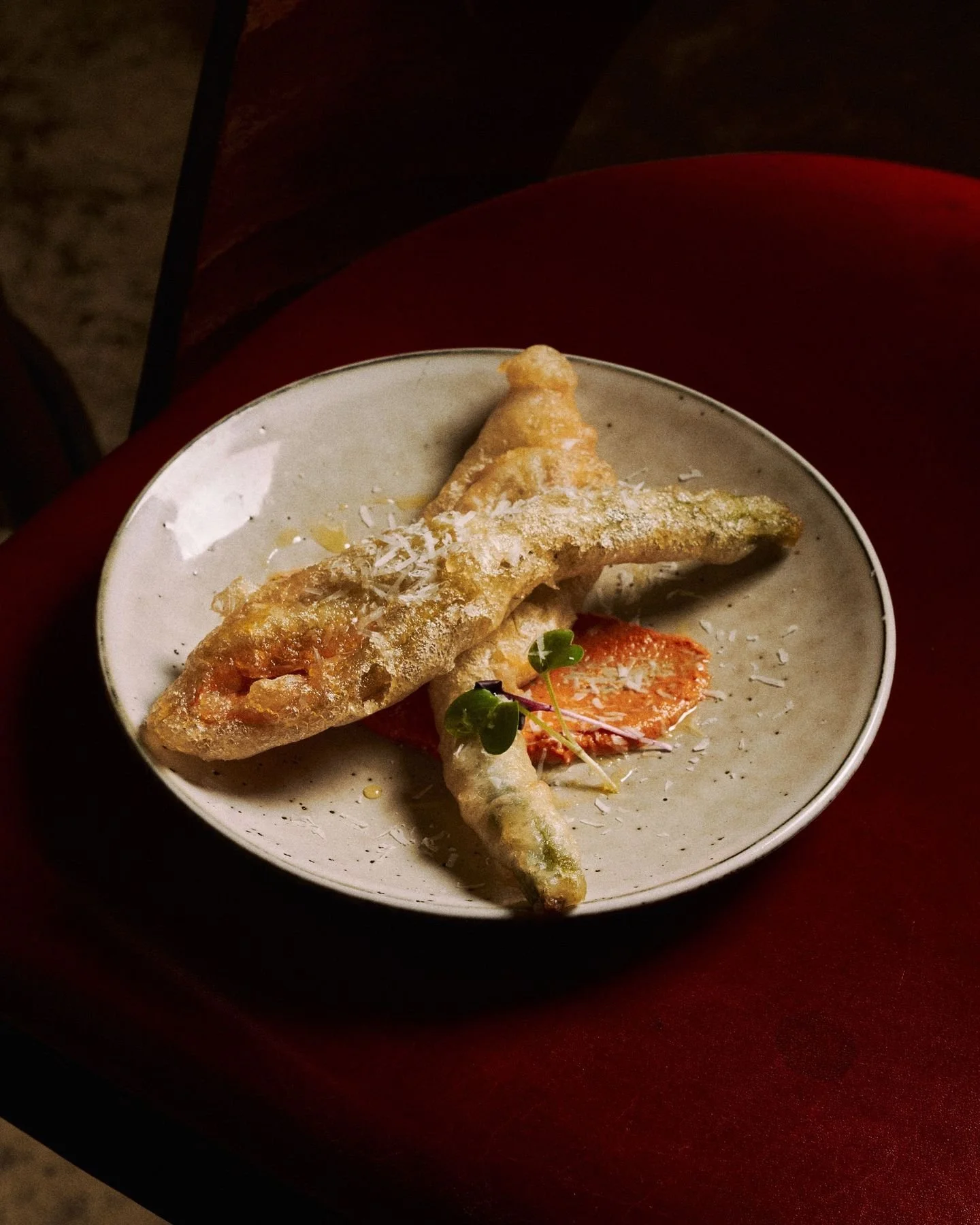 YOUNG ZUCCHINI FLOWERS 
Celebrating the best of the season. Delicate zucchini flowers stuffed with creamy ricotta and roasted pumpkin, finished with Romesco and pecorino. 
Light, layered, and full of seasonal character, this dish is a true taste of