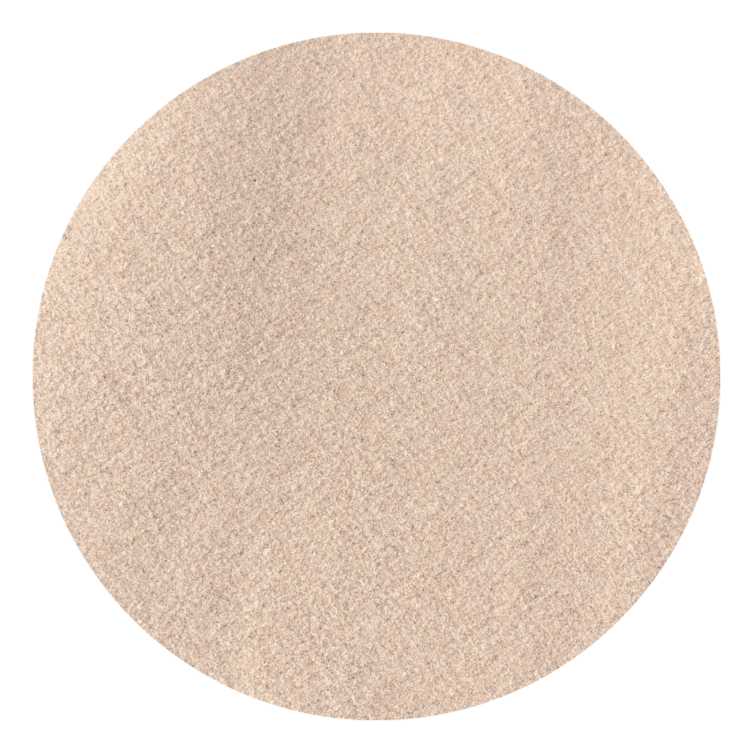A close-up view of a round, beige-colored grainy surface, possibly sand or textured material.