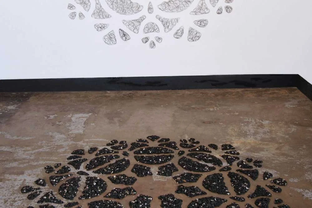 Remnant, coal markings (on wall), 1.64m diameter & High Tide, New Moon, 7 April 2019, sea-washed coal pebbles & sea ephemera, 1.64 m diameter. Shown in In the Making, Project Contemporary Artspace, curated by Catriona Stanton