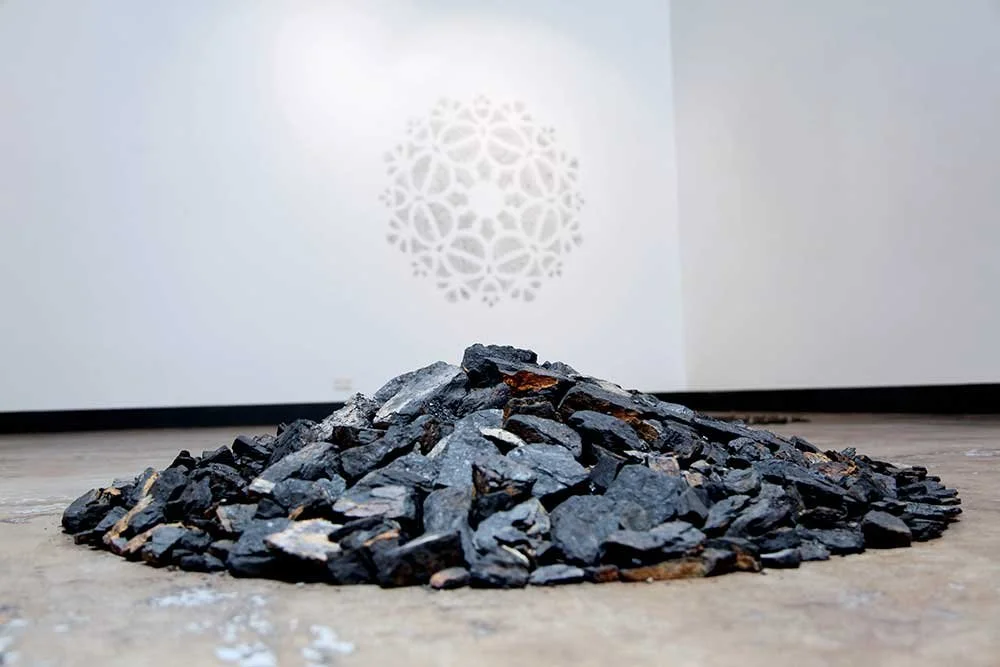 Remnant, coal markings (on wall), 1.64m diameter & Turning of the Tide (at 1.03 metres high), coal collected from landslip, 1.03m diameter. Shown in In the Making, Project Contemporary Artspace, curated by Catriona Stanton