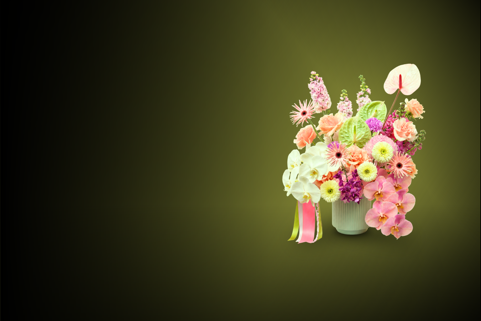 A colorful bouquet of various flowers in a white vase on a dark green gradient background.