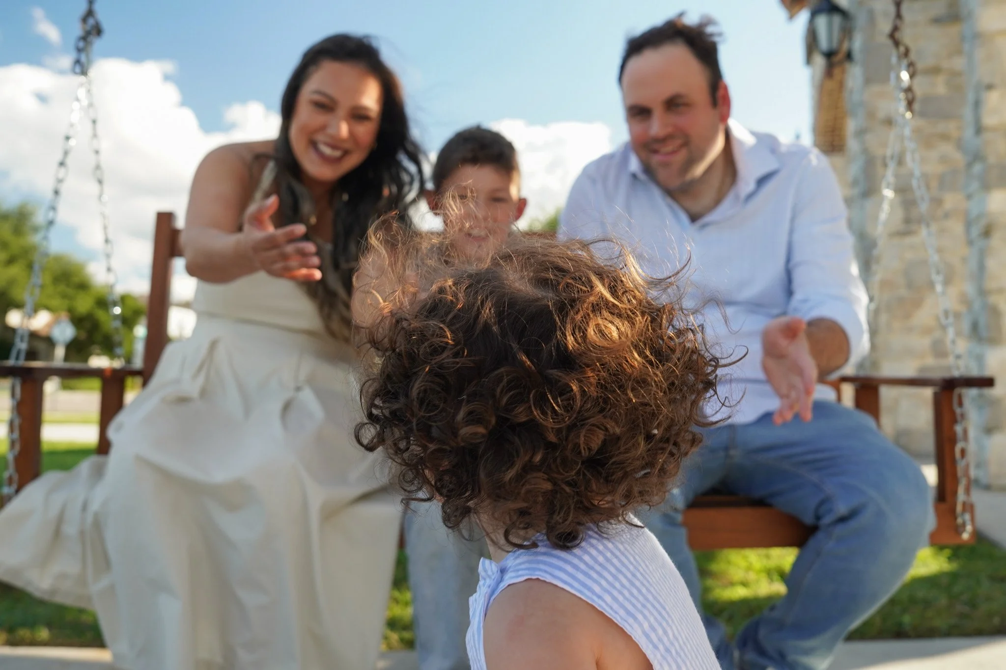 Family enjoying time together on an outdoor porch swing
