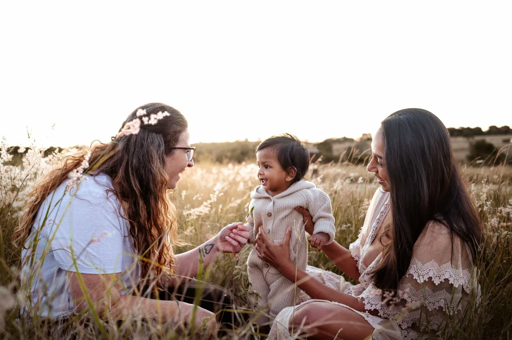 Close-up of a child's small hand grasping an adult's larger hand, symbolizing connection and care.