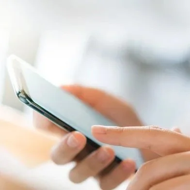 Person holding and using a smartphone.