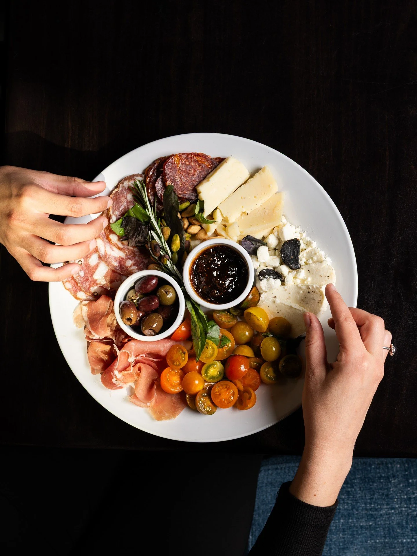 "It starts with the ingredients.

Cured meats sliced in-house.
Cheeses selected for balance and depth.
Everything built to be shared, passed, and experienced together.

This is where the table fills up,
the conversation settles in,
and every det