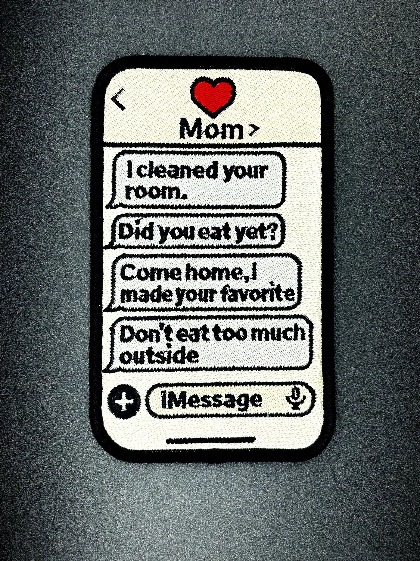 an embroidery patch showing an imessage chat with mom checking in on you