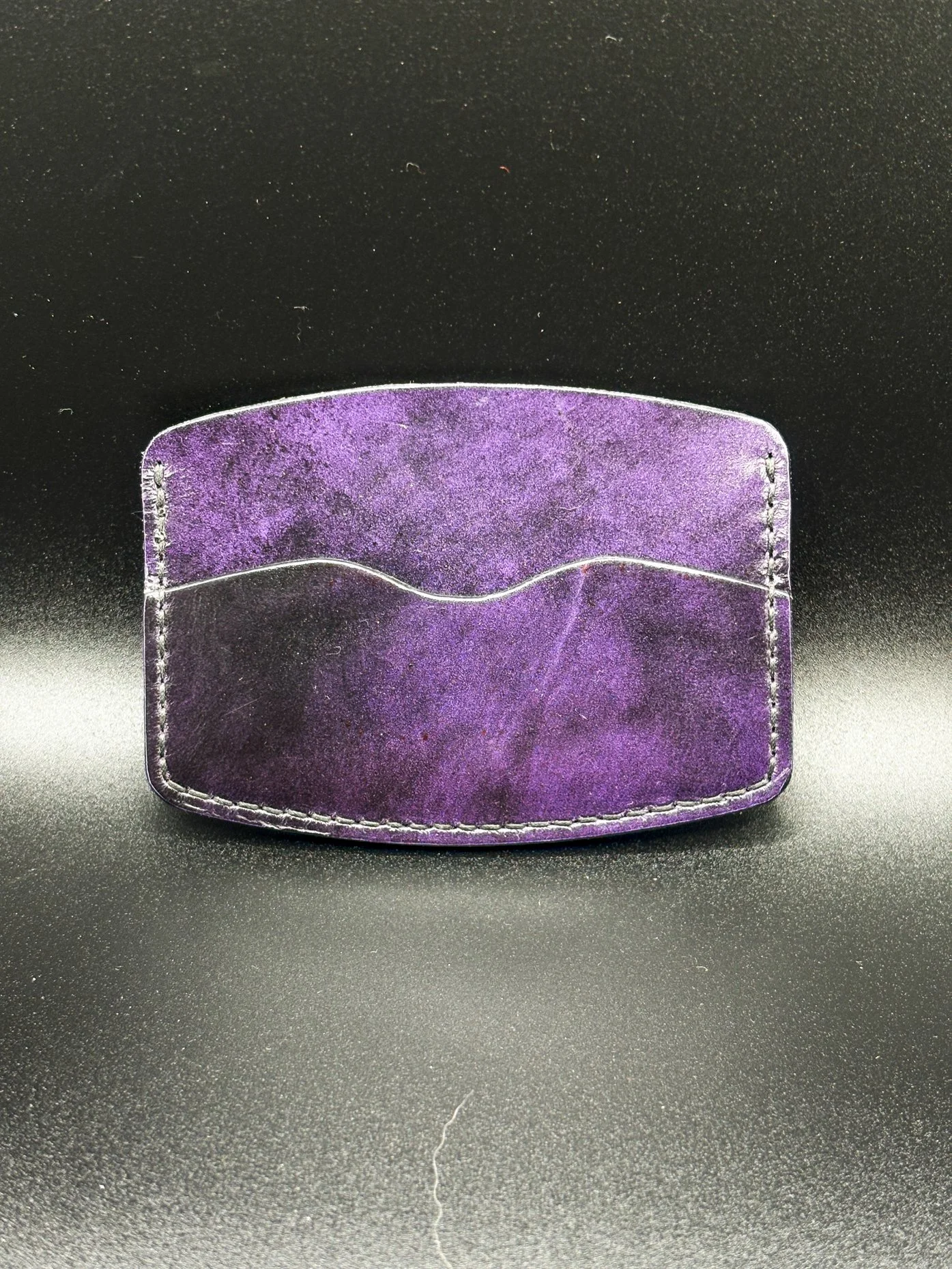 a small purple hard leather wallet with white seam by chen creative studio