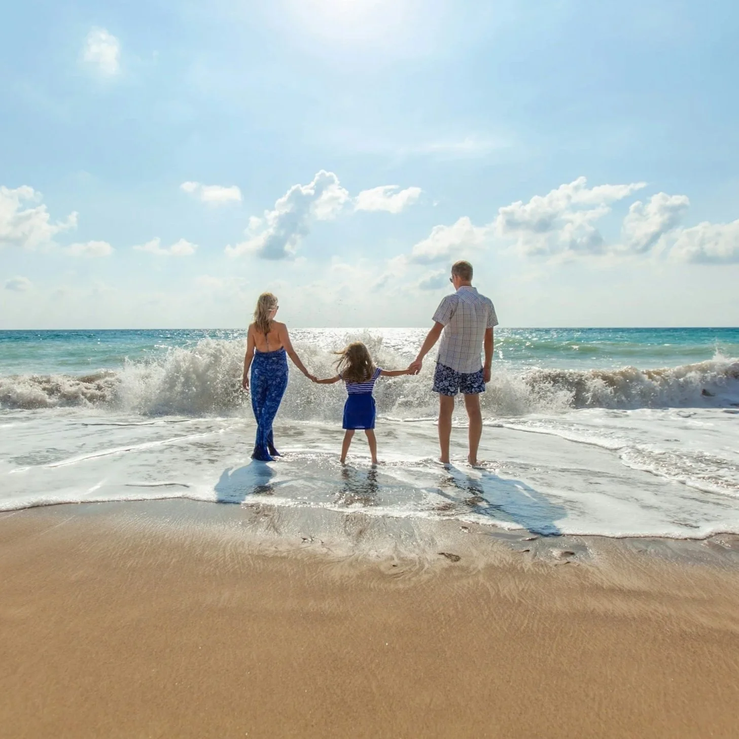 Family walking by the ocean — insurance to protect your family and income