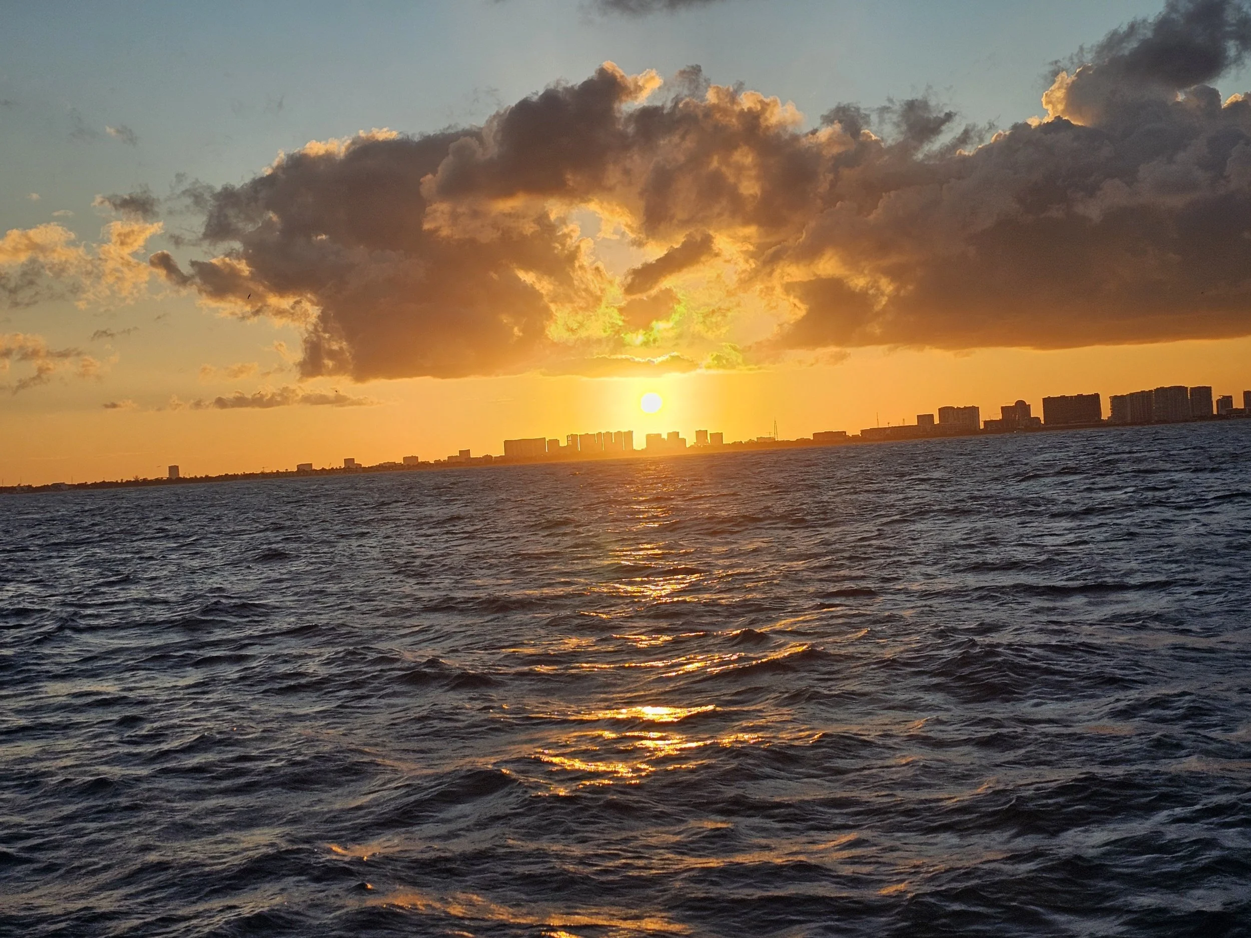 Sunshine over the city and a large body of water