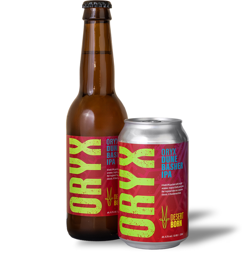 A brown glass bottle and a silver can of Oryx Dune Basher IPA beer with red and neon yellow labels, side by side on a white surface.
