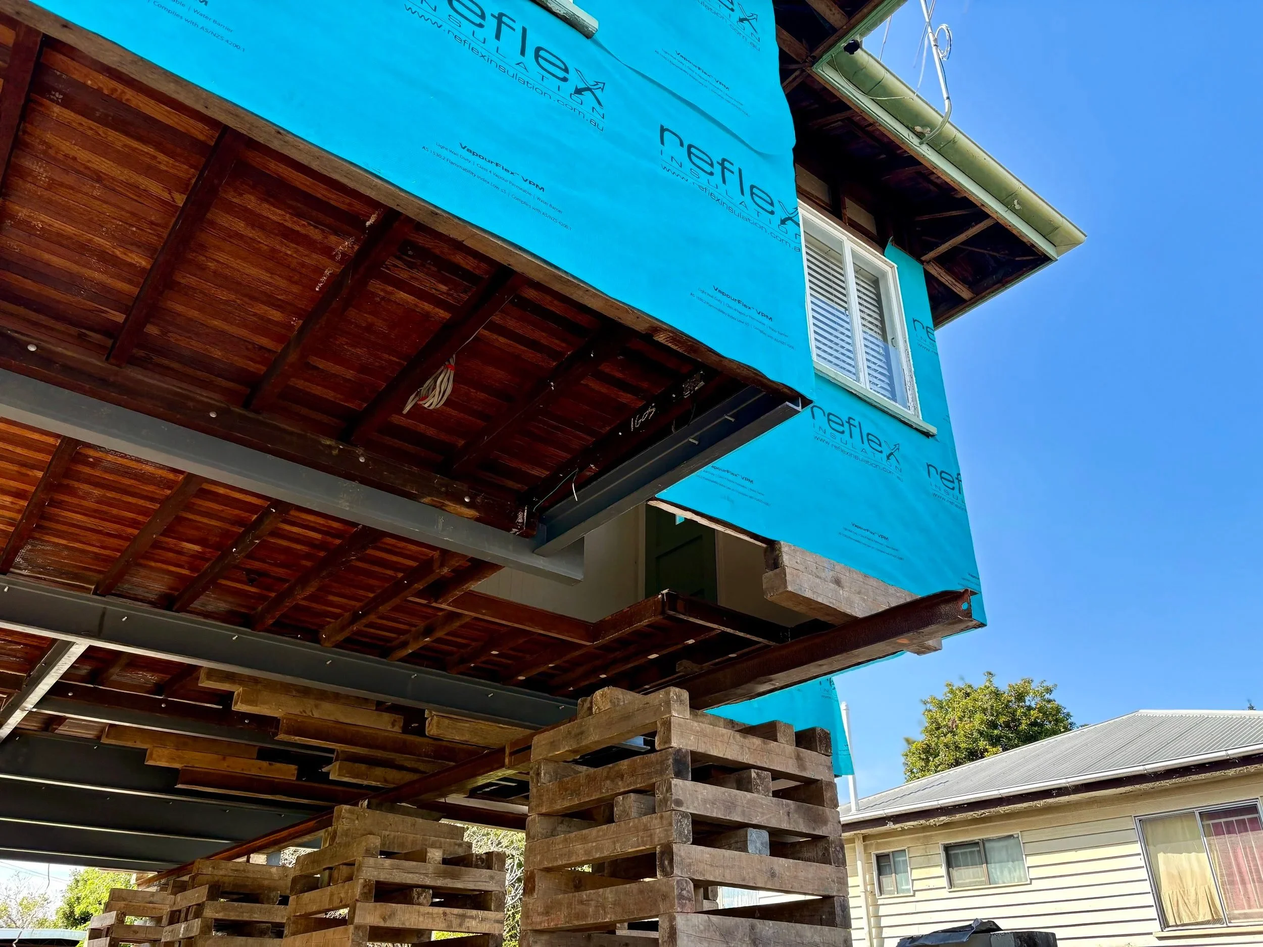 Brisbane post-war home raised on temporary supports in Stafford, Brisbane, , ready for construction of a new ground-level living area.