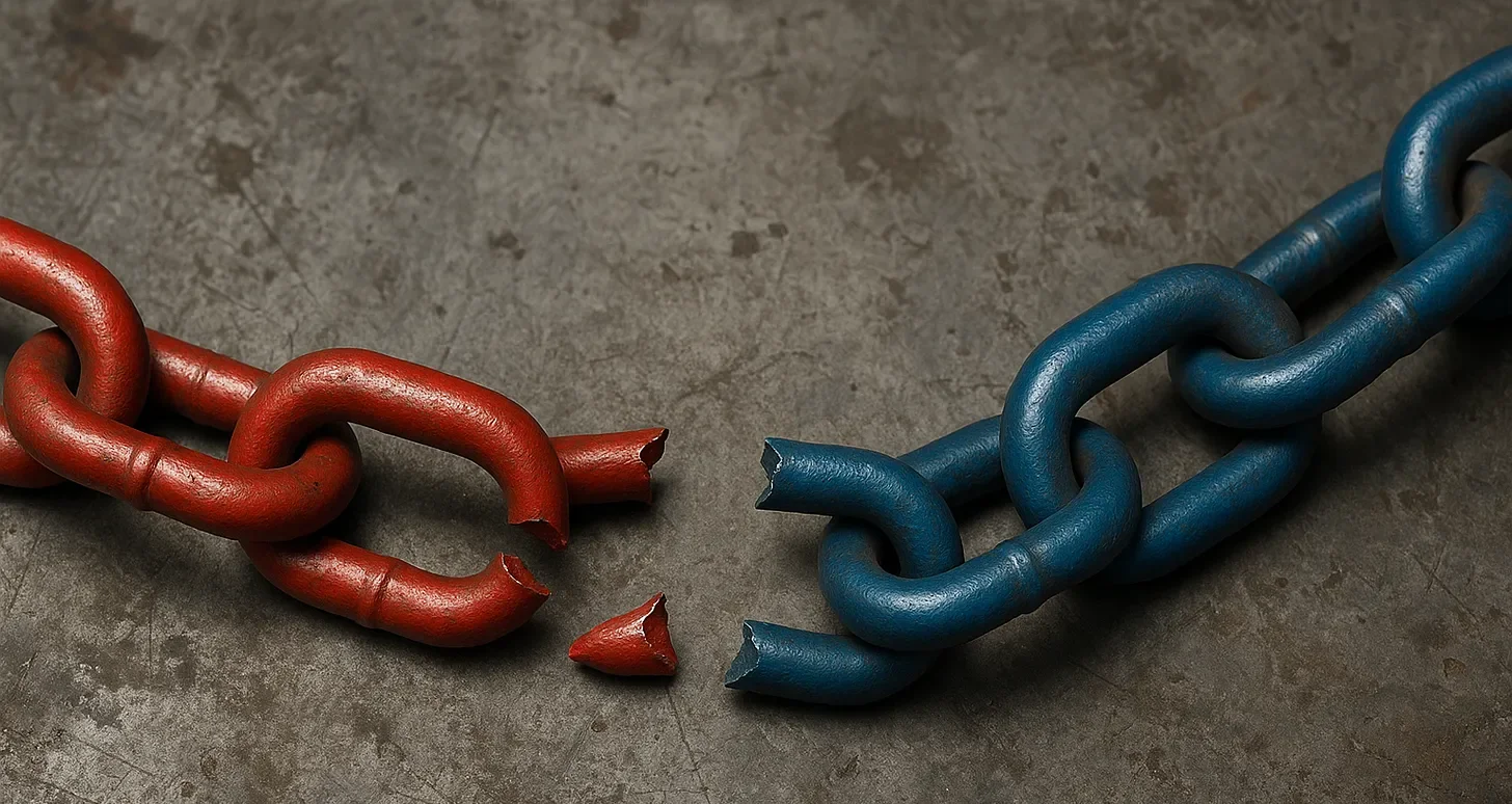 A broken red chain links and a broken blue chain links on a concrete surface.