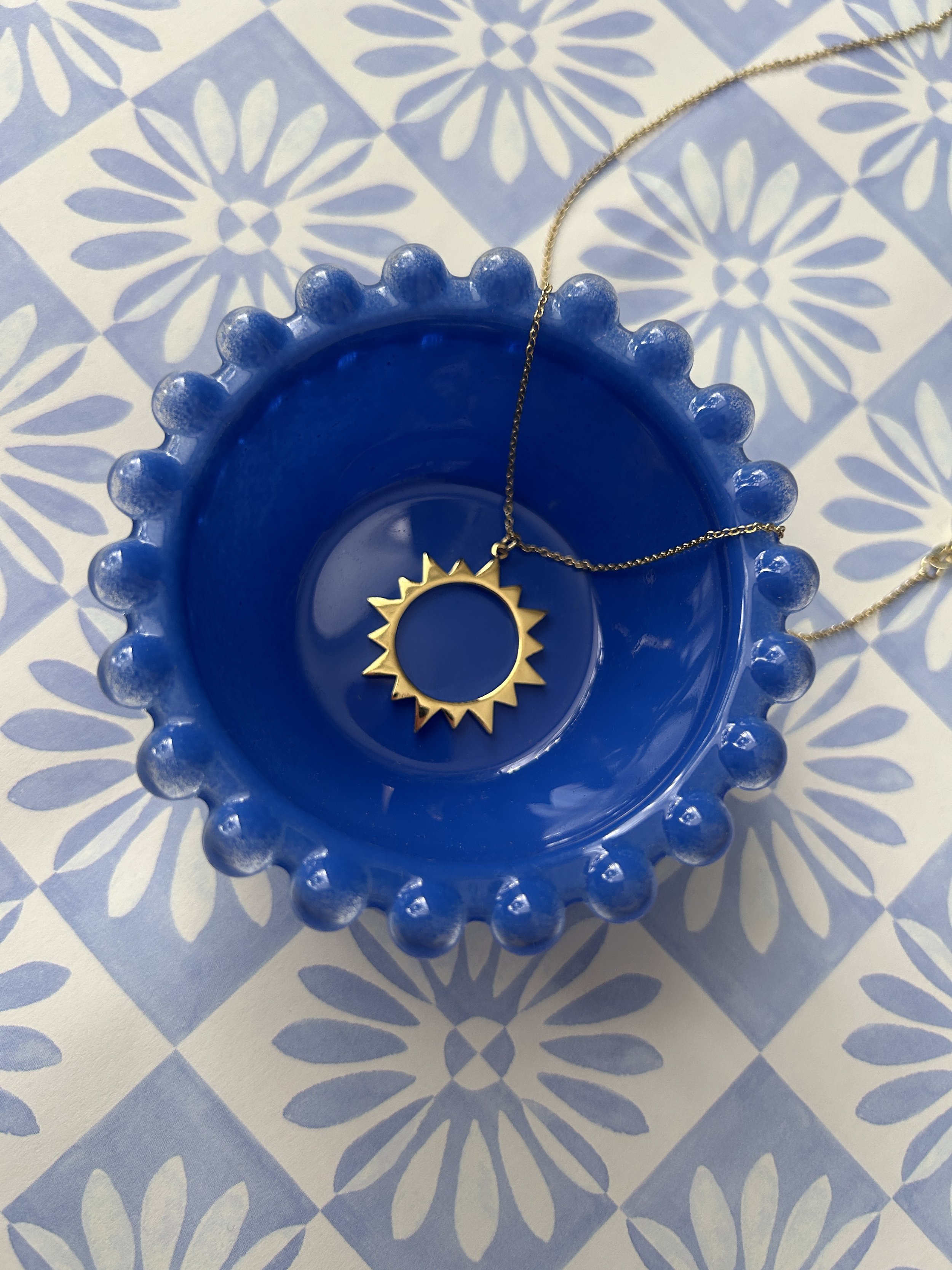 Augusta Jewellery Sun Charm Pendant in blue bowl