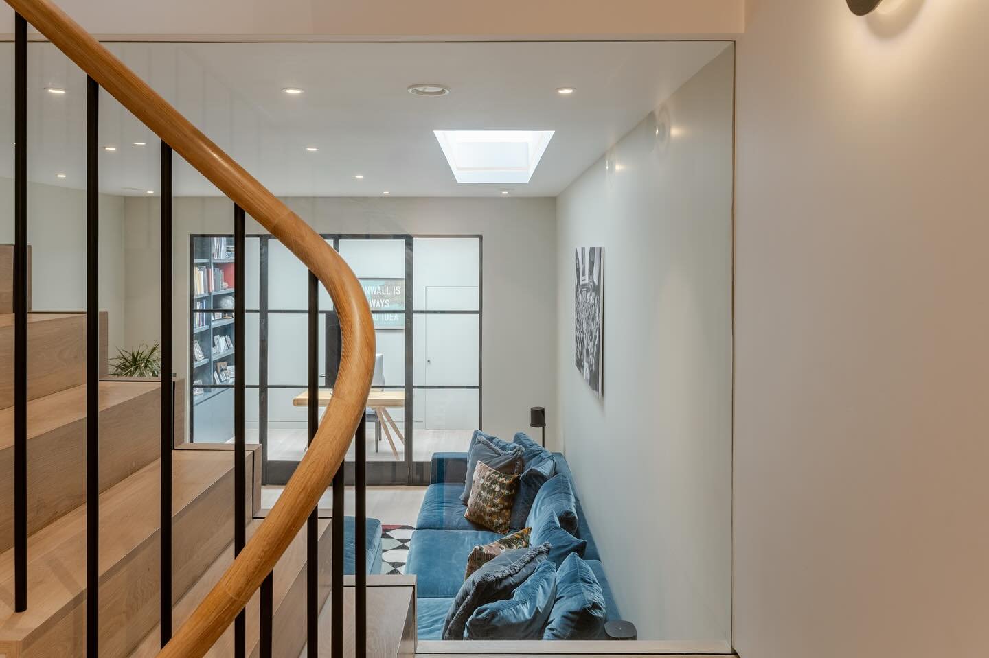 The view through to the media room and the study beyond from the stairs down to the basement in our Clapham project. By moving the stairs from the traditional position below the existing main stairs to the house opened up a lot of opportunities to co
