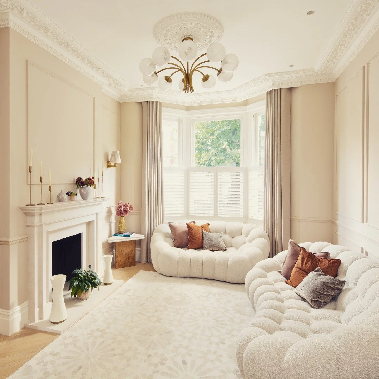 For this lovely, serene and elegant drawing room, we re-introduced period features such as the intricate cornice, ceiling roses, panelling and fireplace, resulting in a great mix of traditional architecture and the client's contemporary furniture. Th
