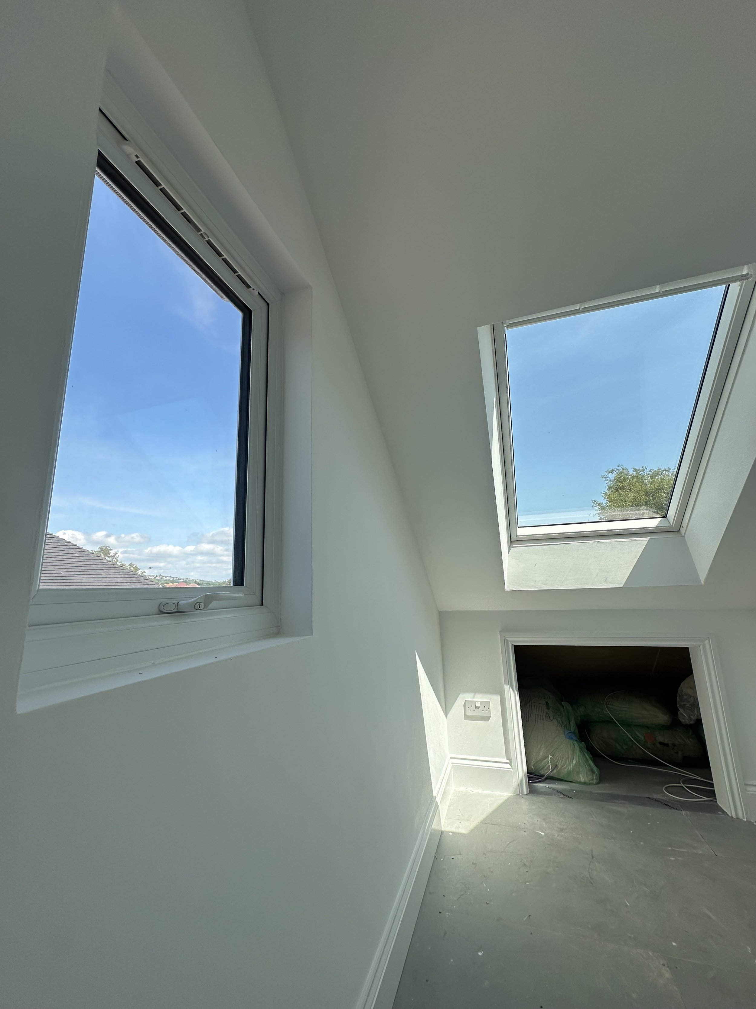 Loft conversion interior with Velux roof windows and natural daylight