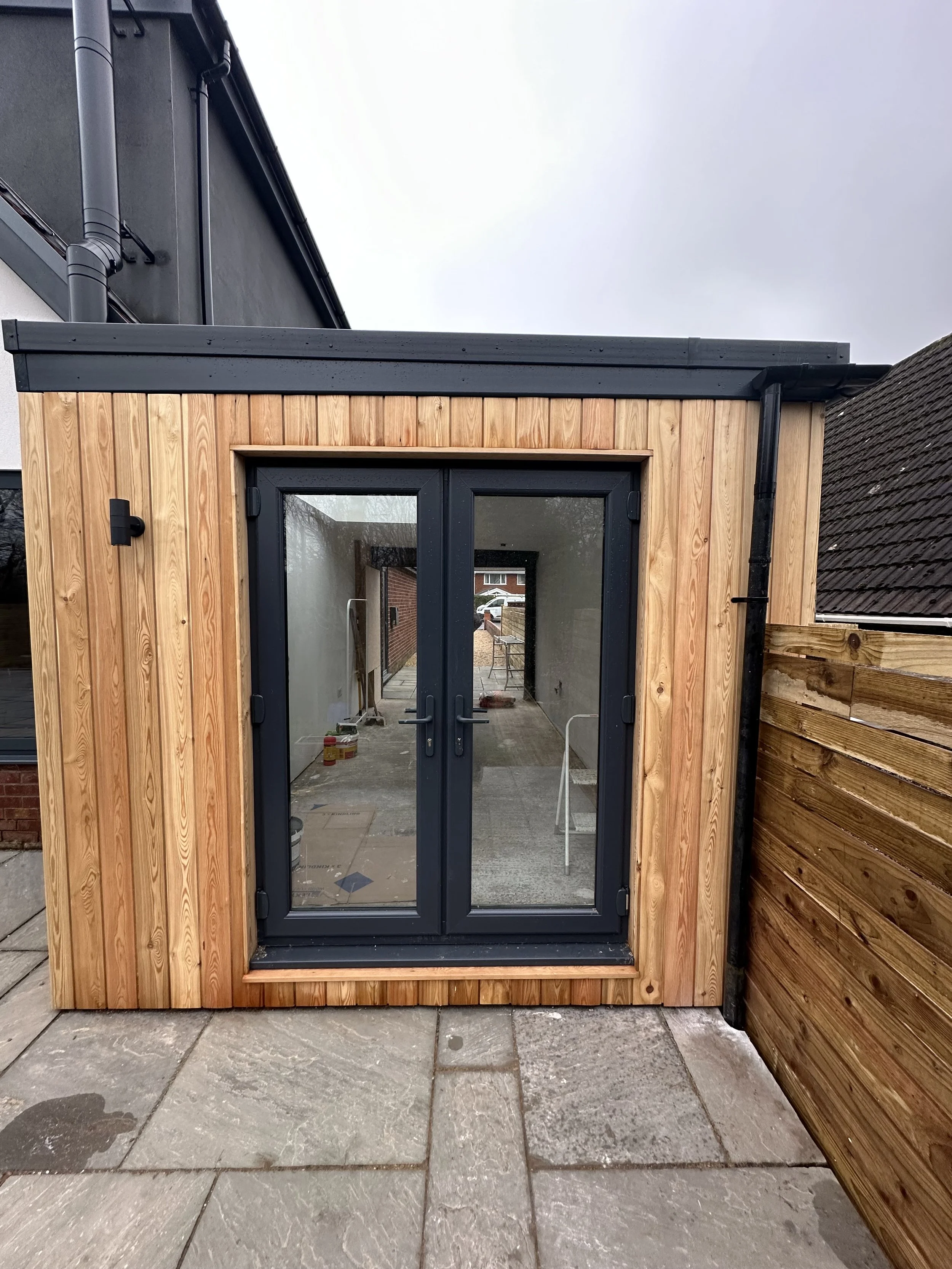 Exterior home renovation with decking and new doors