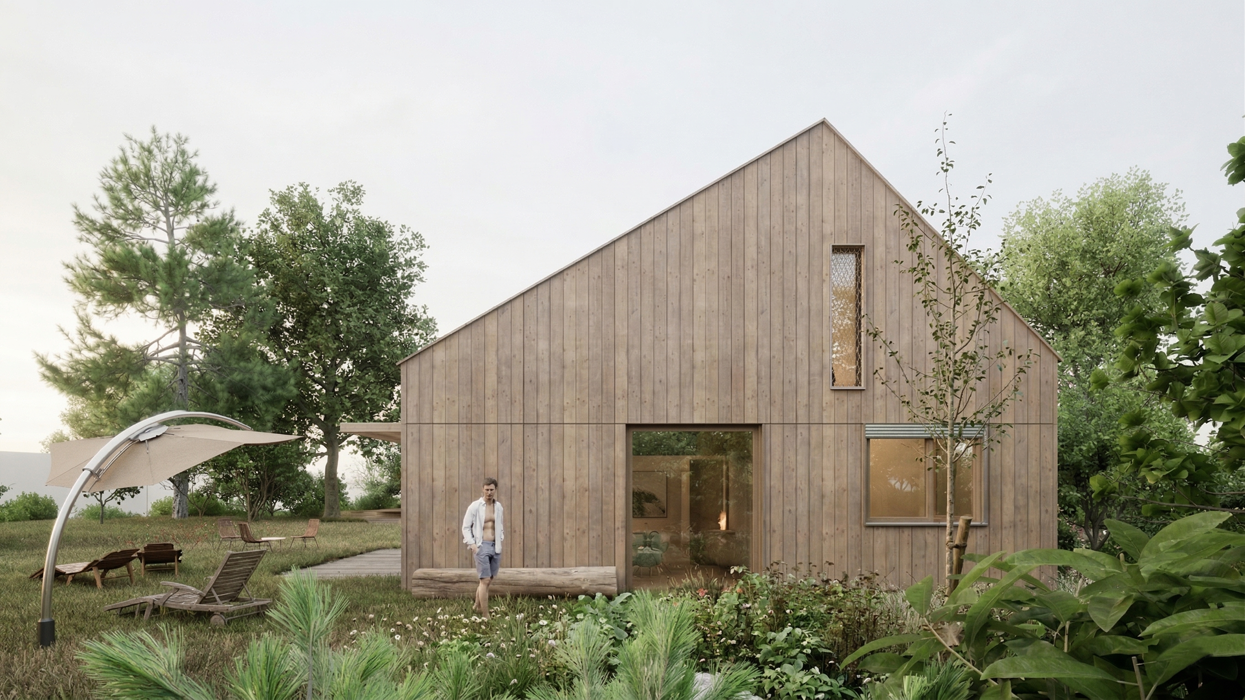 Une maison en bois avec de grandes fenêtres, entourée d'arbres et de végétation, avec un homme debout devant.
