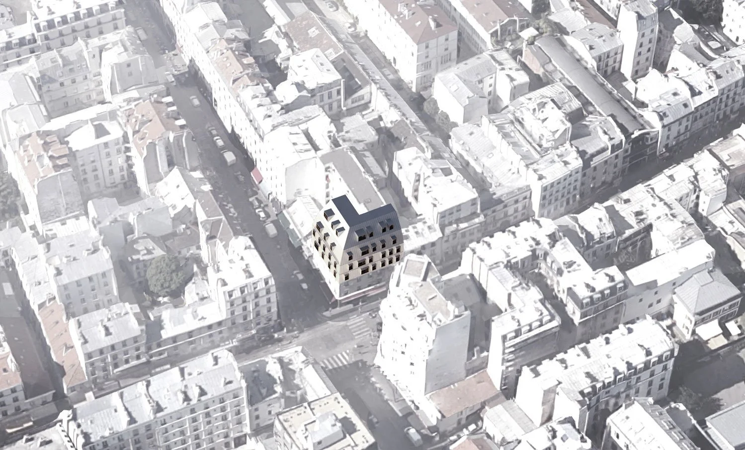 Vue aérienne d'un quartier urbain avec un bâtiment de plusieurs étages mis en valeur au centre.
