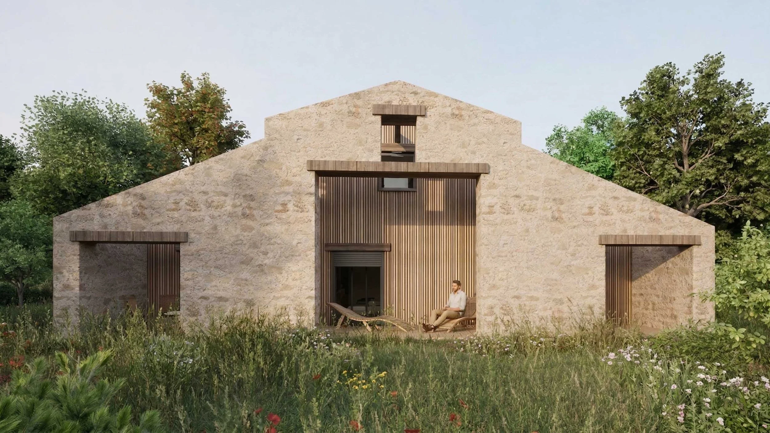 Une maison moderne en pierre avec des palettes en bois, entourée de végétation et d'arbres, avec une personne assise dans un patio en bois
