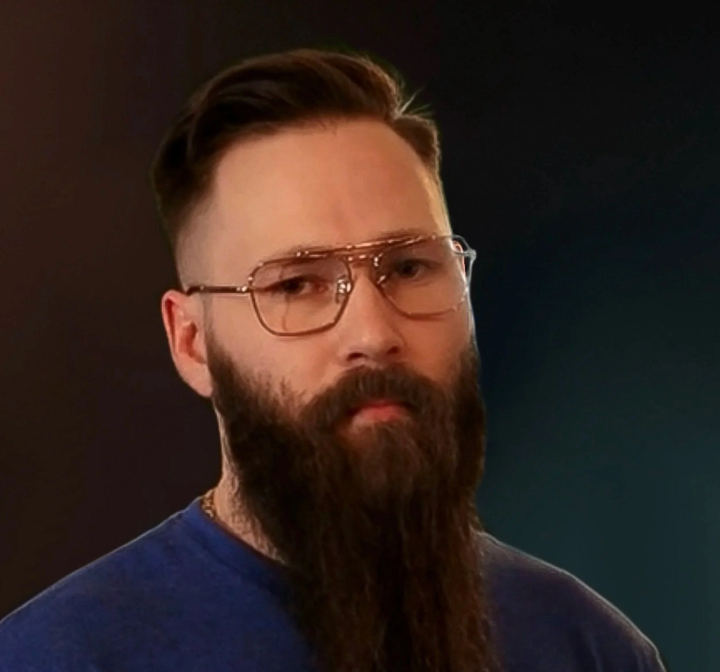 Bearded man with glasses and short hair