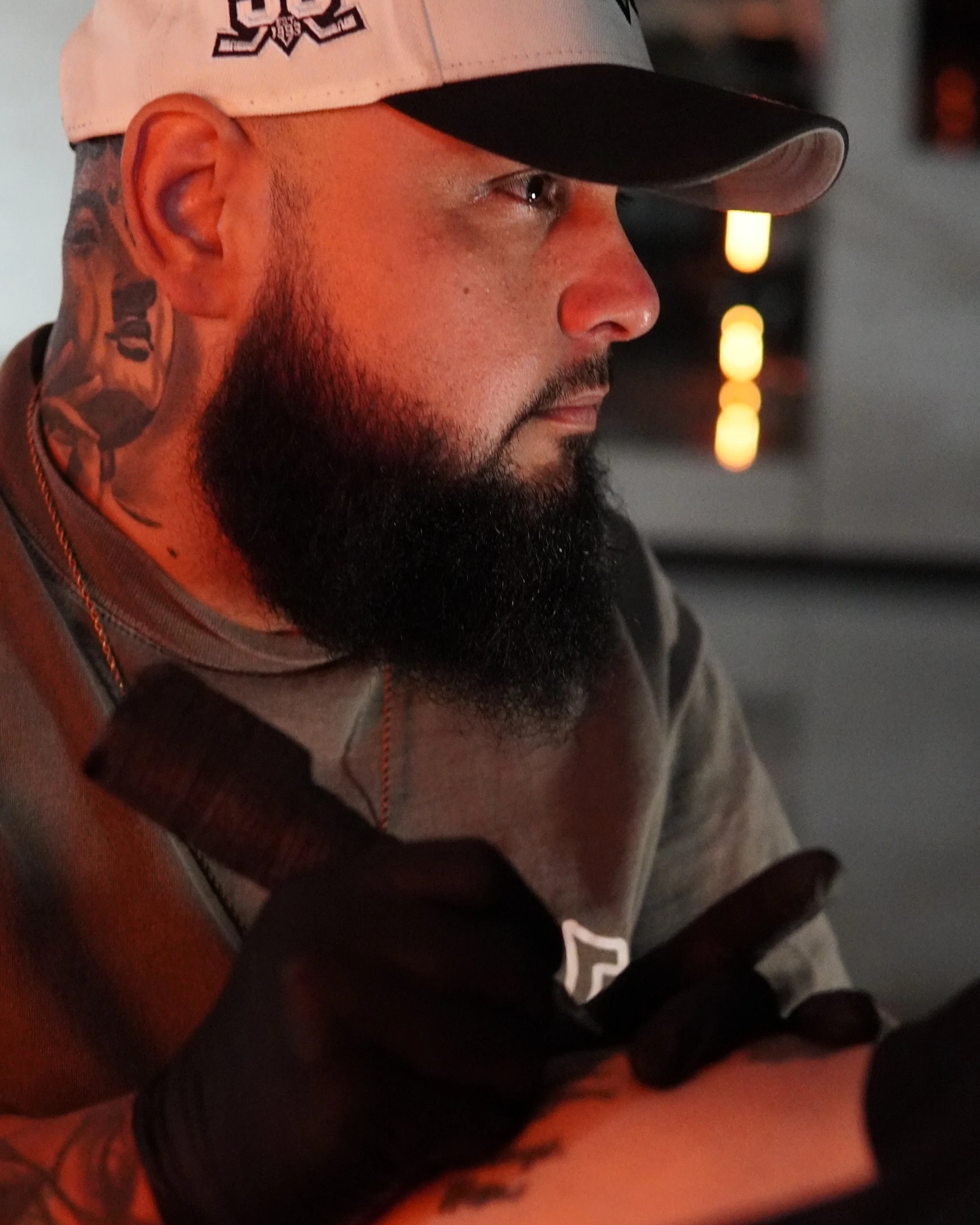 Bearded man with black shirt and gold necklace
