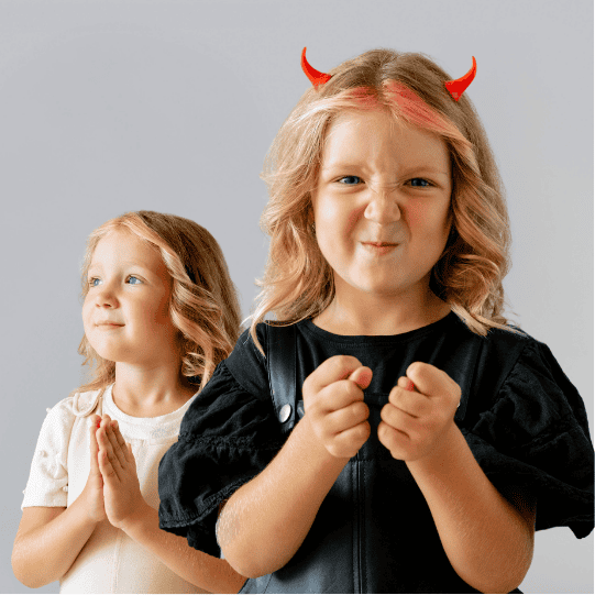 young blonde girl posing as both an angel and a devil