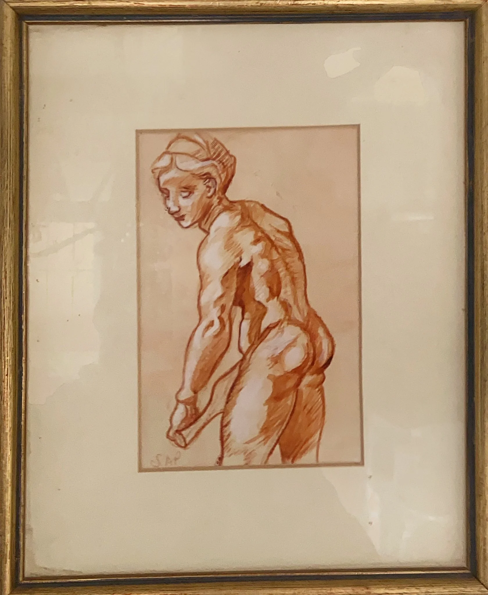 A sepia-toned sketch of a nude woman with short hair, turned slightly away, holding an object in her right hand.