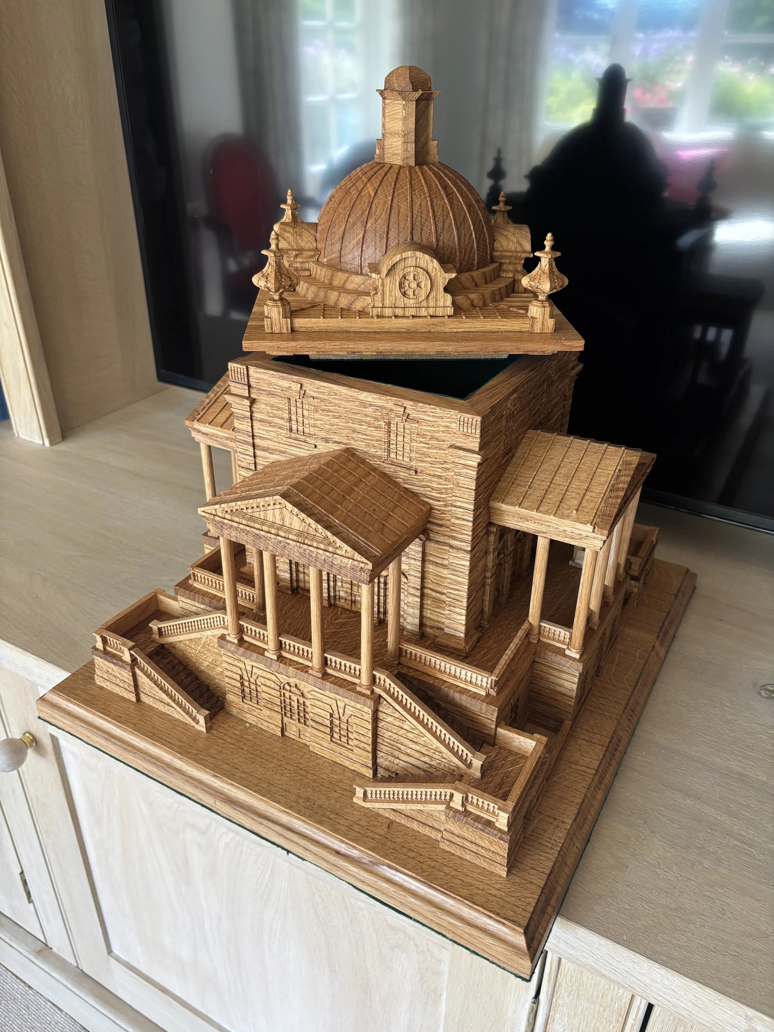 Wooden architectural model resembling a classical building with a dome and multiple staircases.