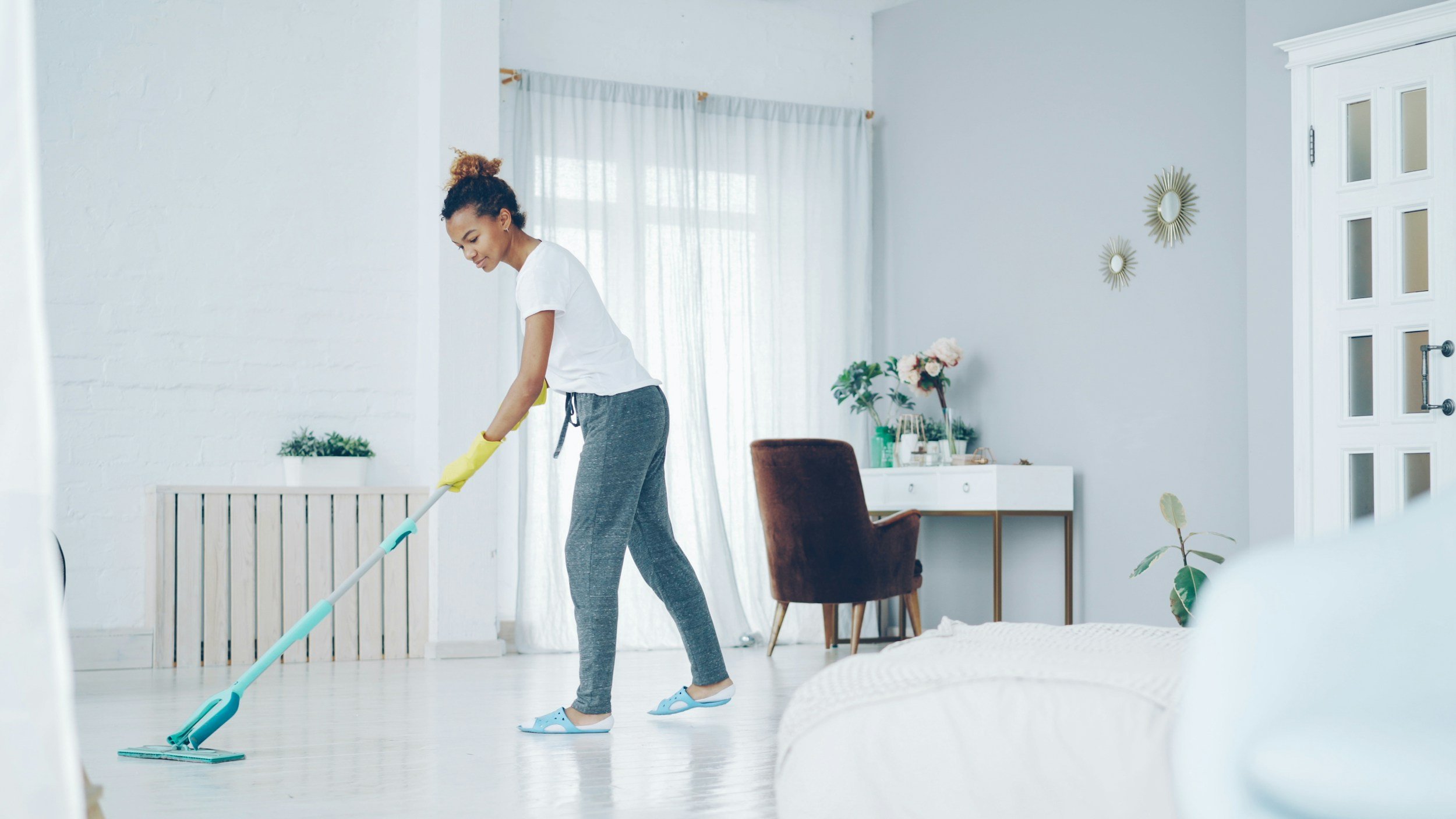 pristine office solutions cleaning company mopping a floor with a women nice home