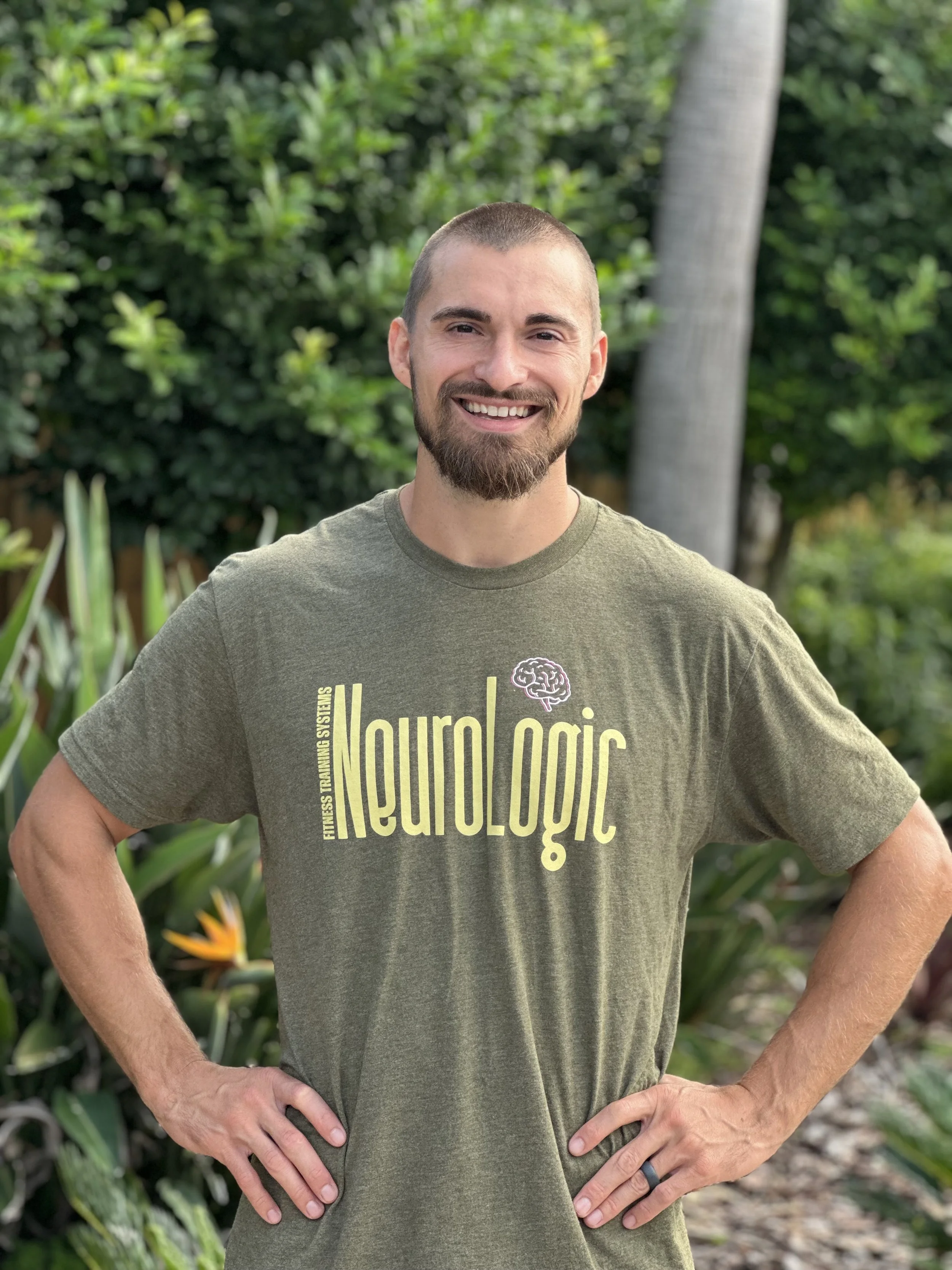 CEO of Neurologic Fitness Training Systems wearing branded t-shirt with large font and small brain logo.