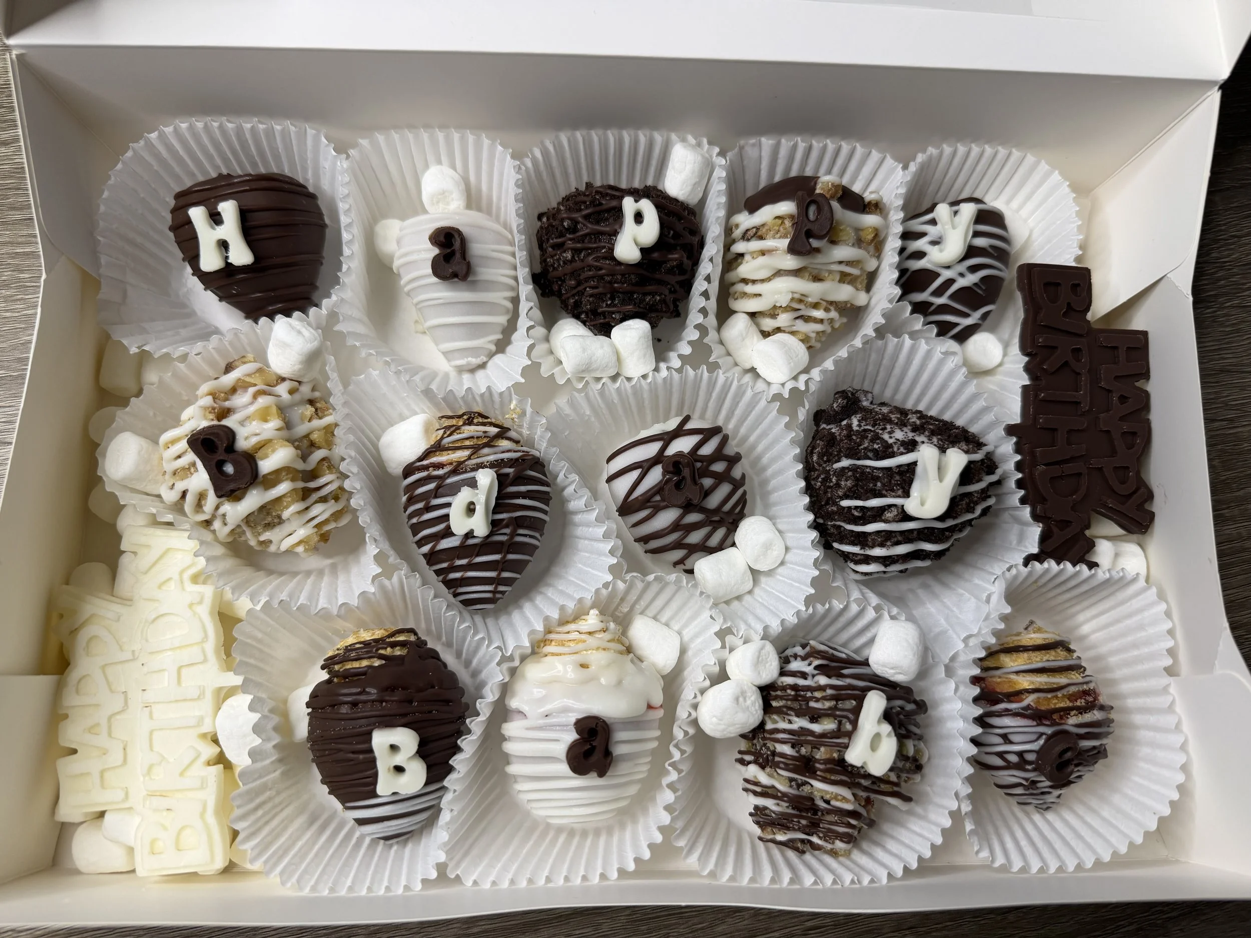 Sweet Somethings — Assorted hand-dipped berries that spell it out.