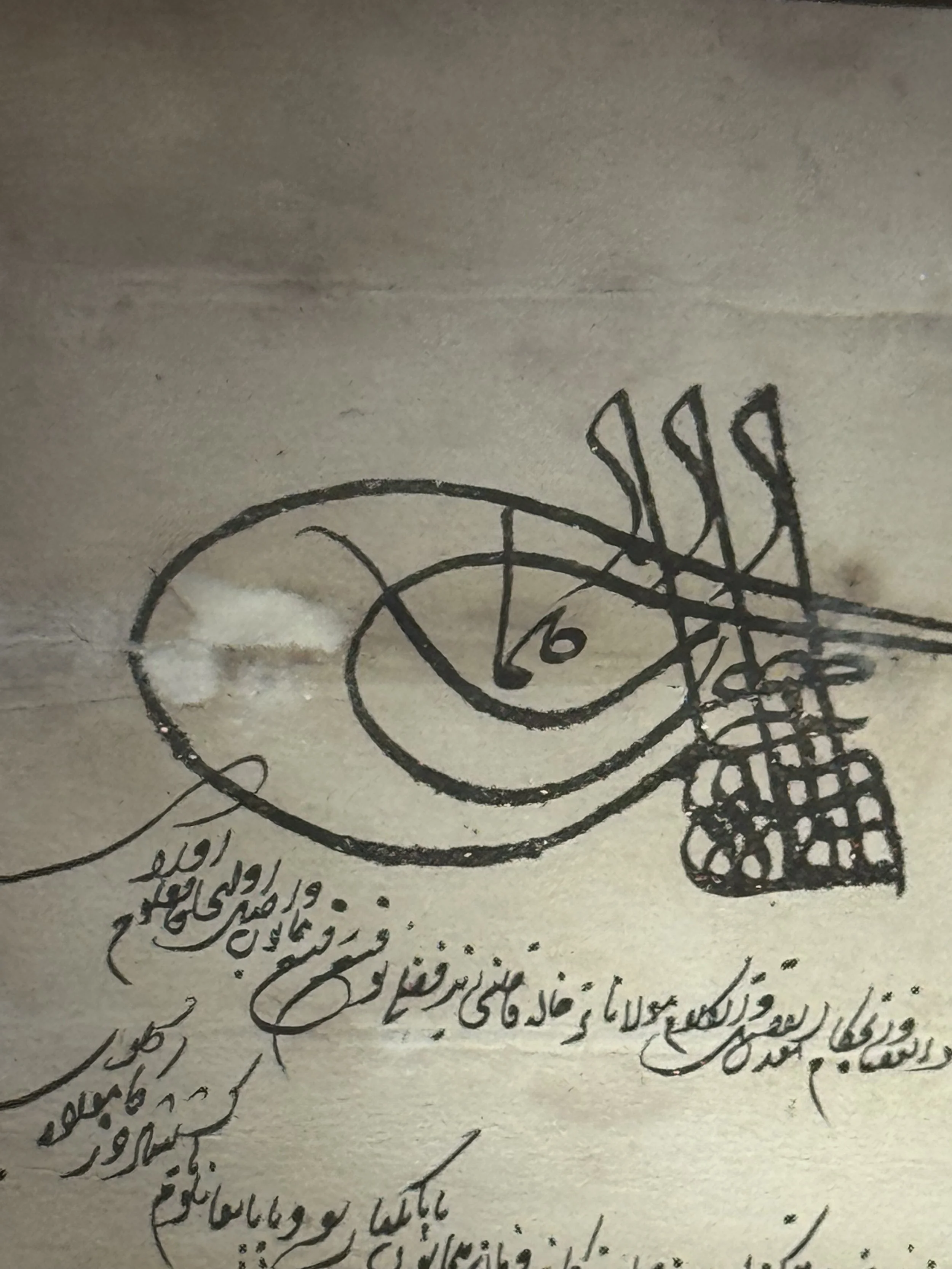 A detailed, intricate drawing or diagram with some Persian or Urdu script. The drawing includes a large eye-shaped figure with marks around it, along with handwritten notes.
