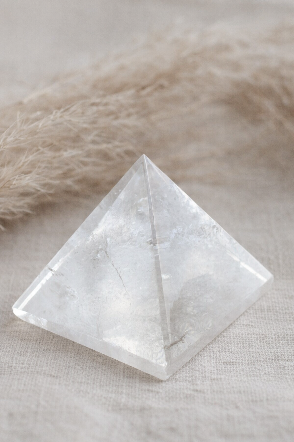 1 Clear quartz pyramid on beige fabric.png