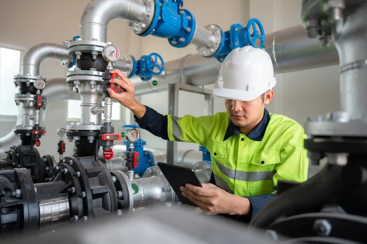 Engineer carrying out remedial works on industrial pipework