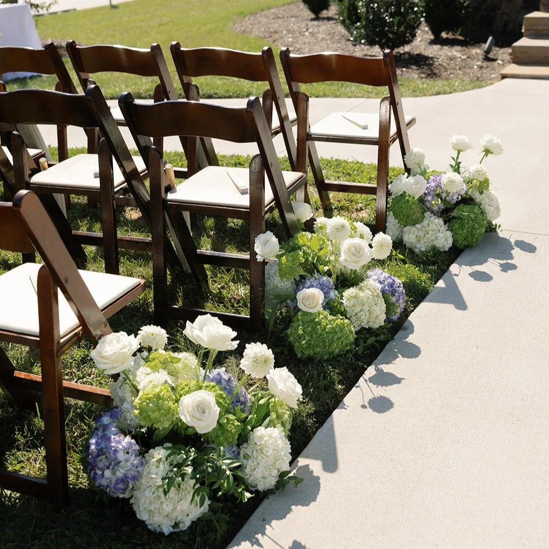 We love a big ground meadow making a statement down the aisle. These can then be repurposed in front of sweetheart tables, bars, cake tables, dj booths etc. 
**And how adorable are the flower shadows on the sidewalk in this photo??!!