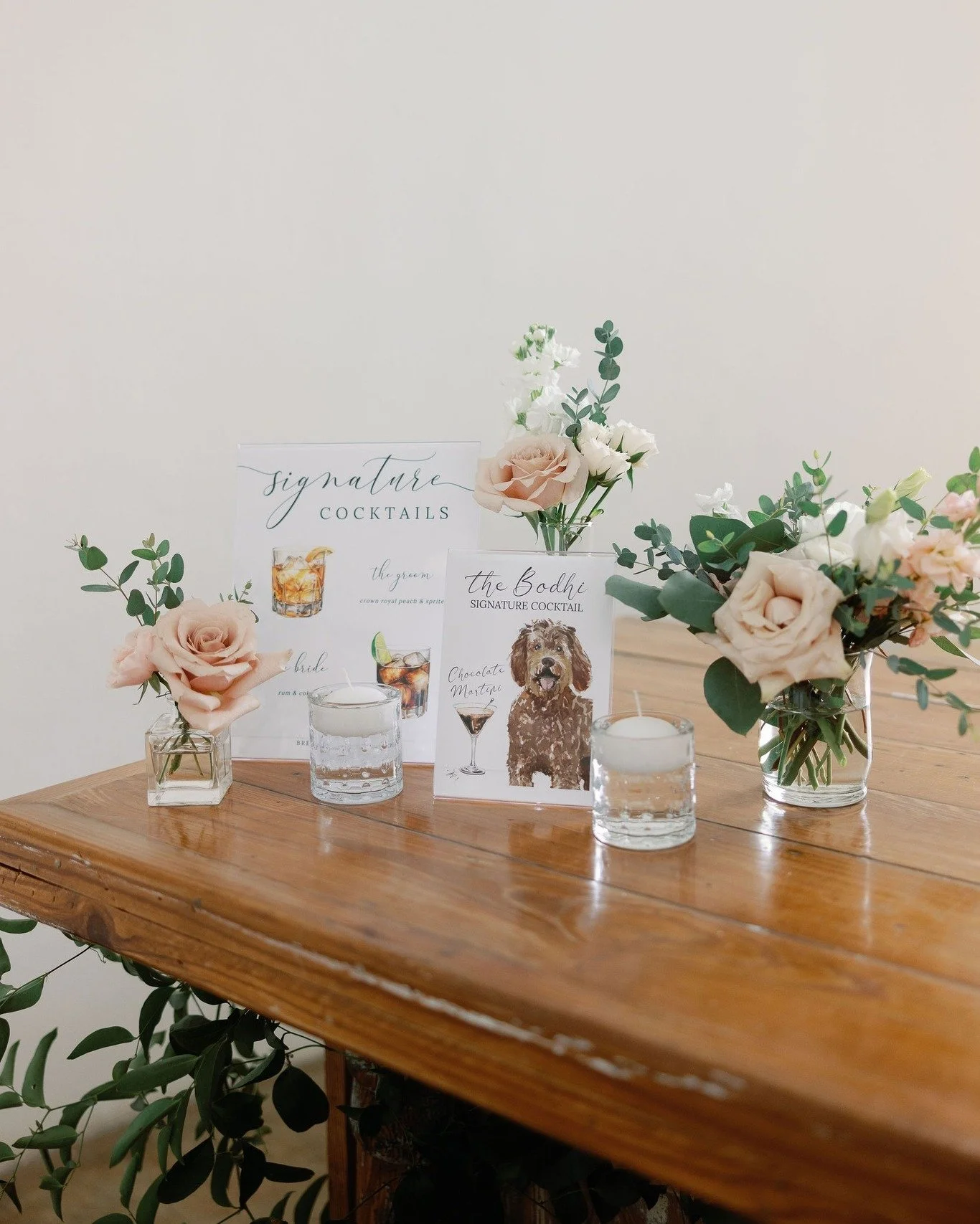 Bar Florals and candles to accent your custom bar signage. We also tucked some smilax along the bar front. 
venue: @barnatreynoldavillage