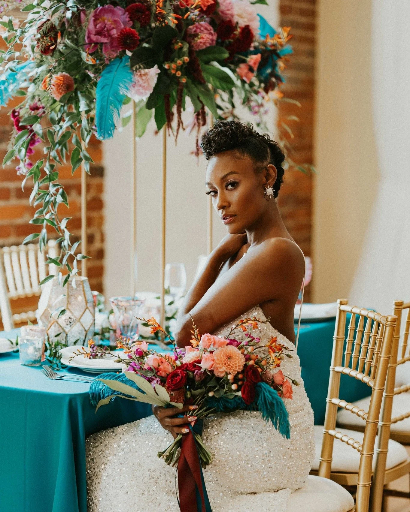 This was such a fun photoshoot a few years back at Revolution Mill. We got to play with a color palette we don't get to utilize that much and use teal ostrich feathers. How much more fun than that.