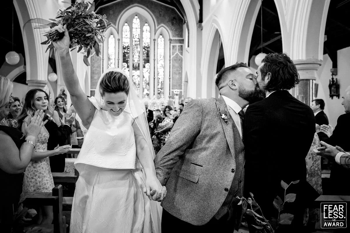 An award winning wedding photographer catches a great moment as the bride and groom leaving their Dublin wedding ceremony