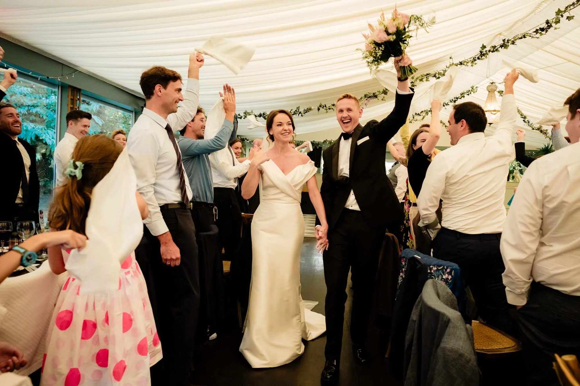 bride and groom makign an entrance into dinner in tinakilly house