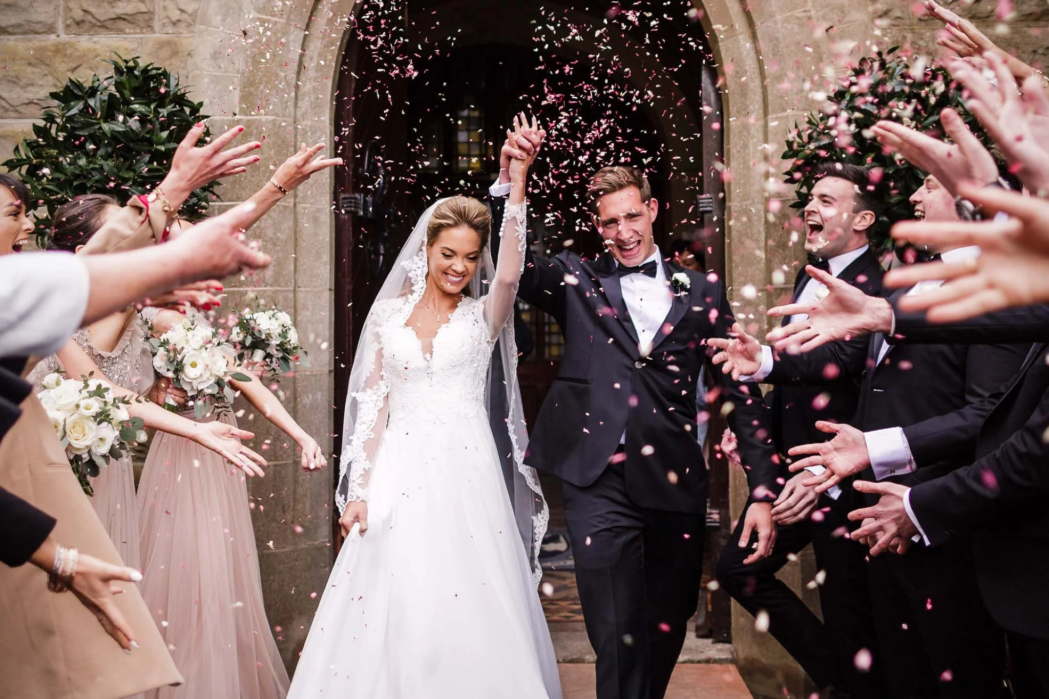 wedding photograph of the bride and groom exiting under a cloud of confetti in the K-Club, KildateBride & b