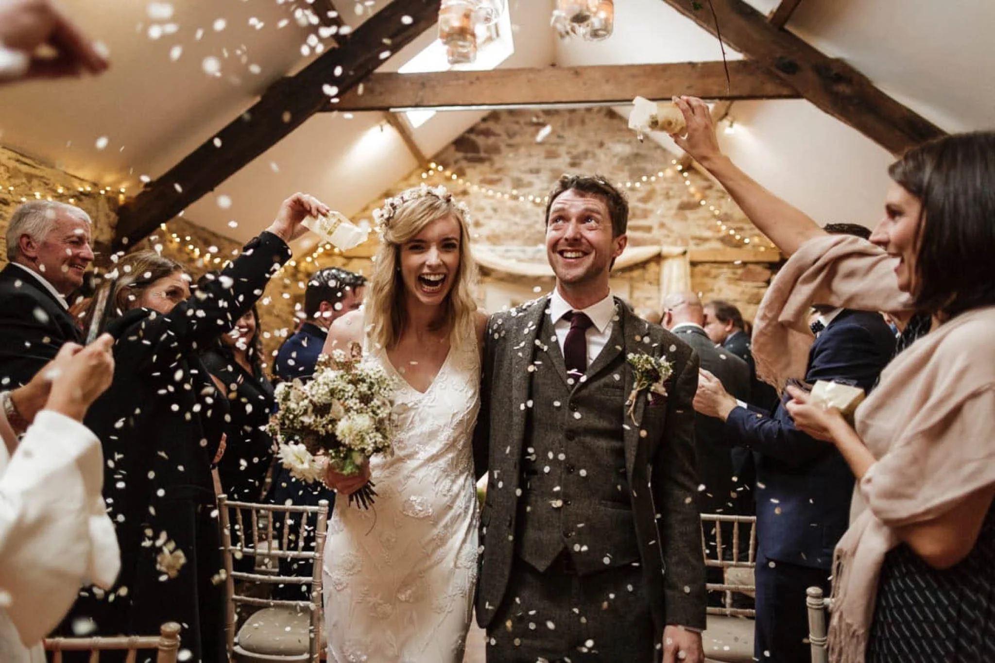 Married couple exiting their wedding ceremony beaming with happiness in murphystown barn, Wexford.