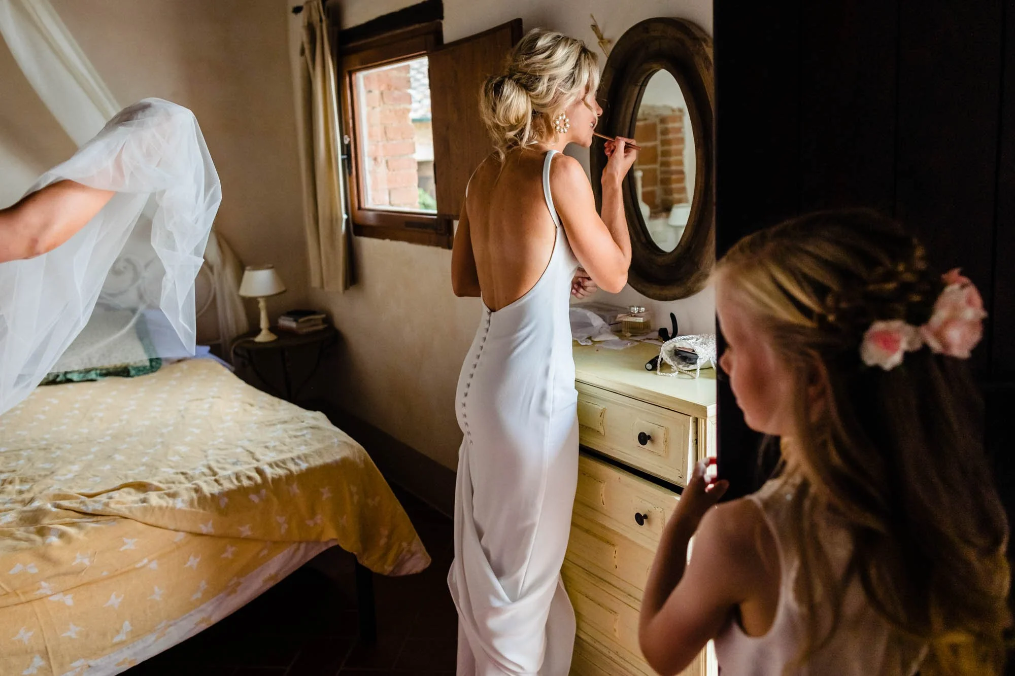 An elegant wedding photograph of the bride in her bridal suite in a destination wedding in Italy by Irish wedding photographer Annie Kheffache
