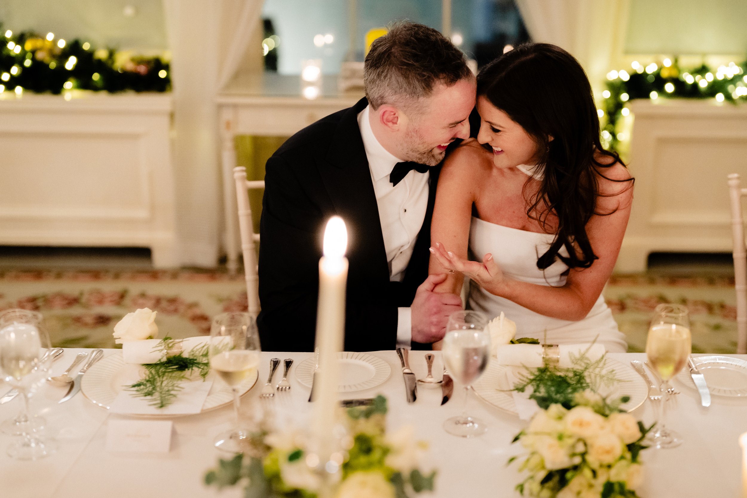 A documentary wedding photographer captures a small moment between the bride and groom in the dining room at the Merrion Hotel at their intimate small wedding in Dublin
