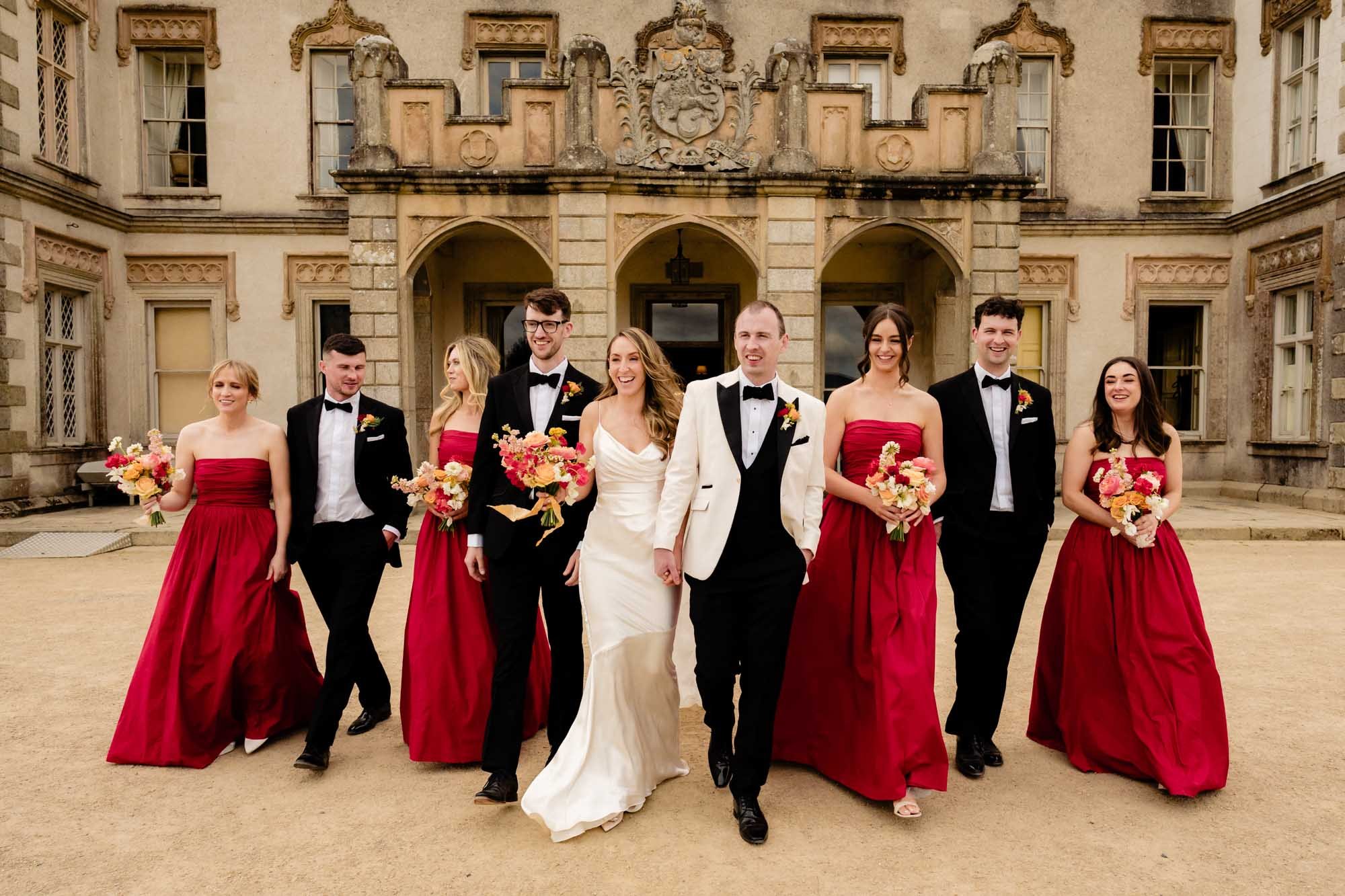 Bridesmaids and groomsmen walking with the bride and groom in a natural looking wedding photograph at Borris House